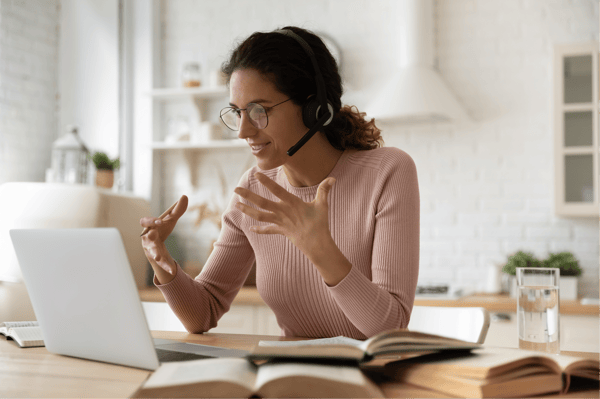 Woman leading tutoring session on laptop.