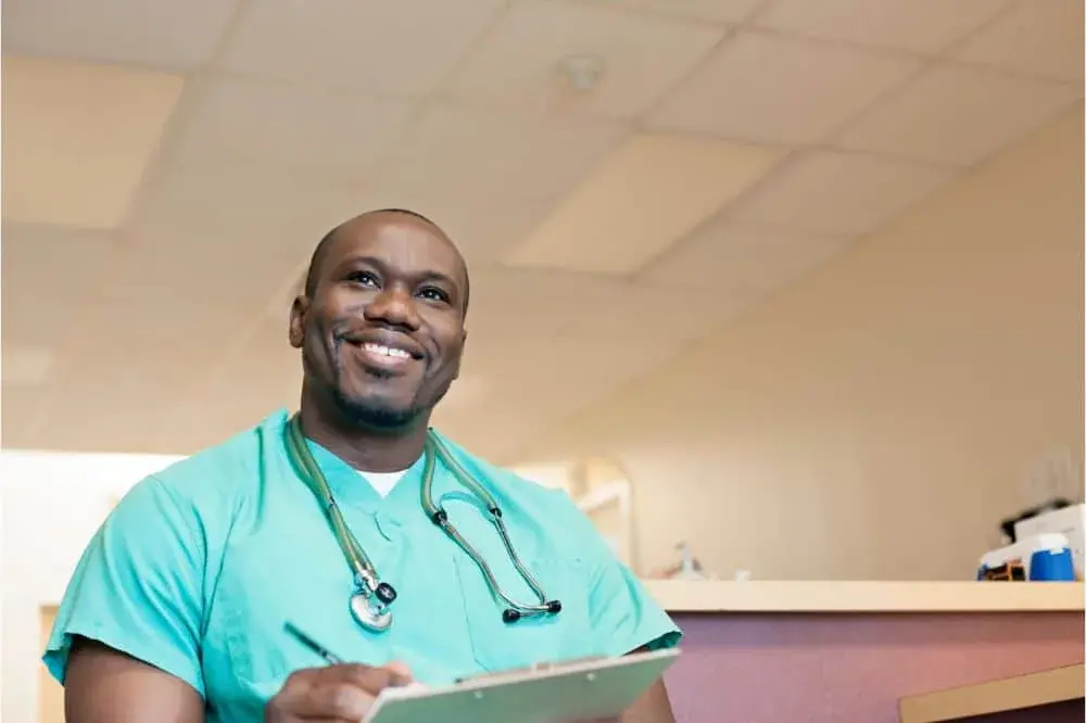 Resident holding a clipboard and smiling